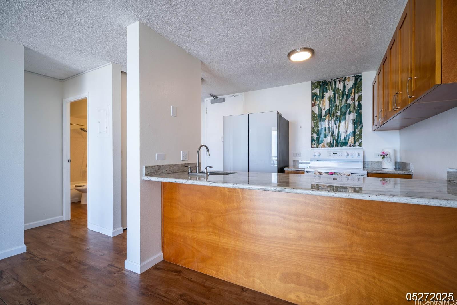 98-99 Uao Place, Unit 1705 Aiea, HI 96701 - Photo 13 of 25 a large kitchen with stainless steel appliances granite countertop a refrigerator and a sink