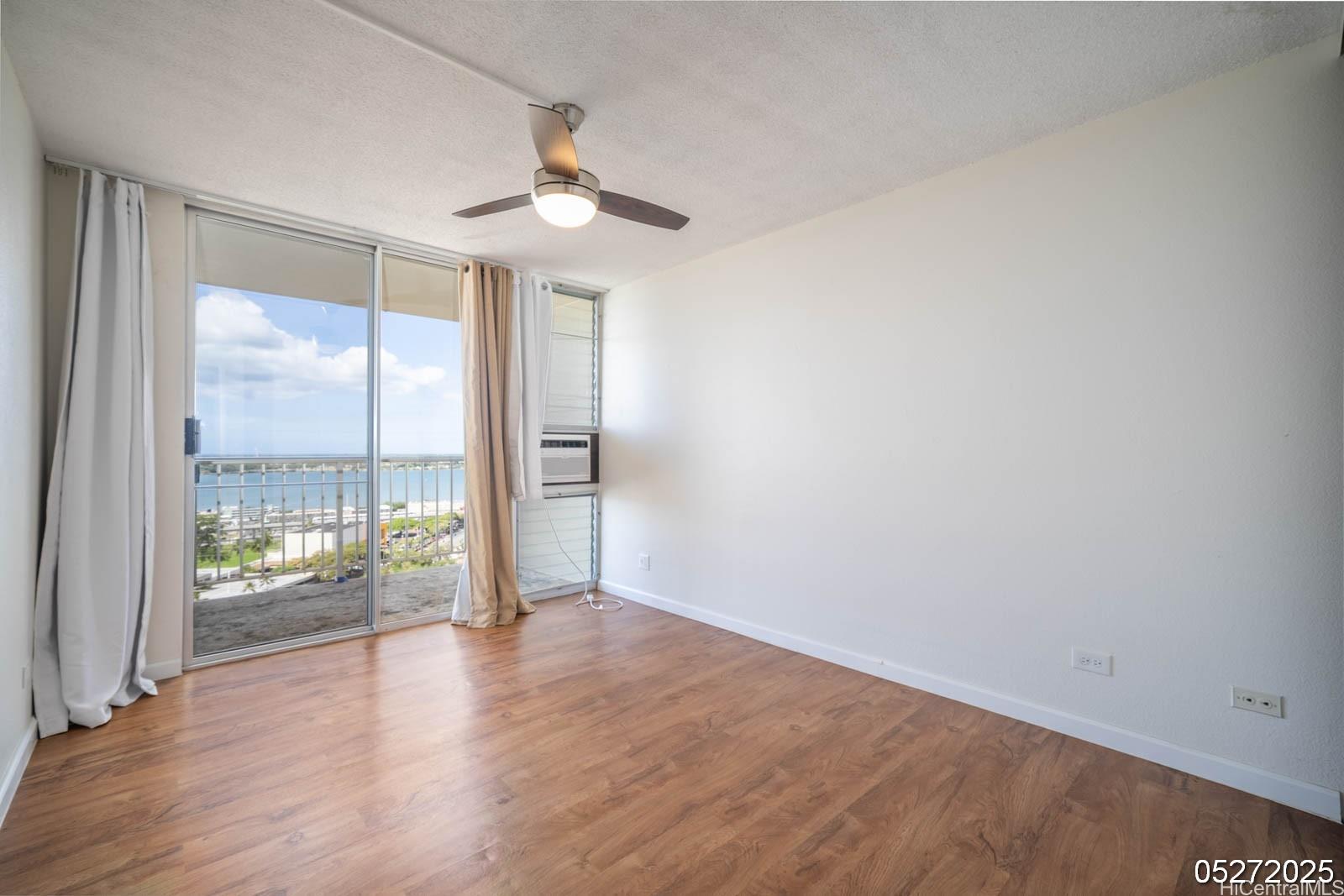 98-99 Uao Place, Unit 1705 Aiea, HI 96701 - Photo 20 of 25 wooden floor in an empty room with a window