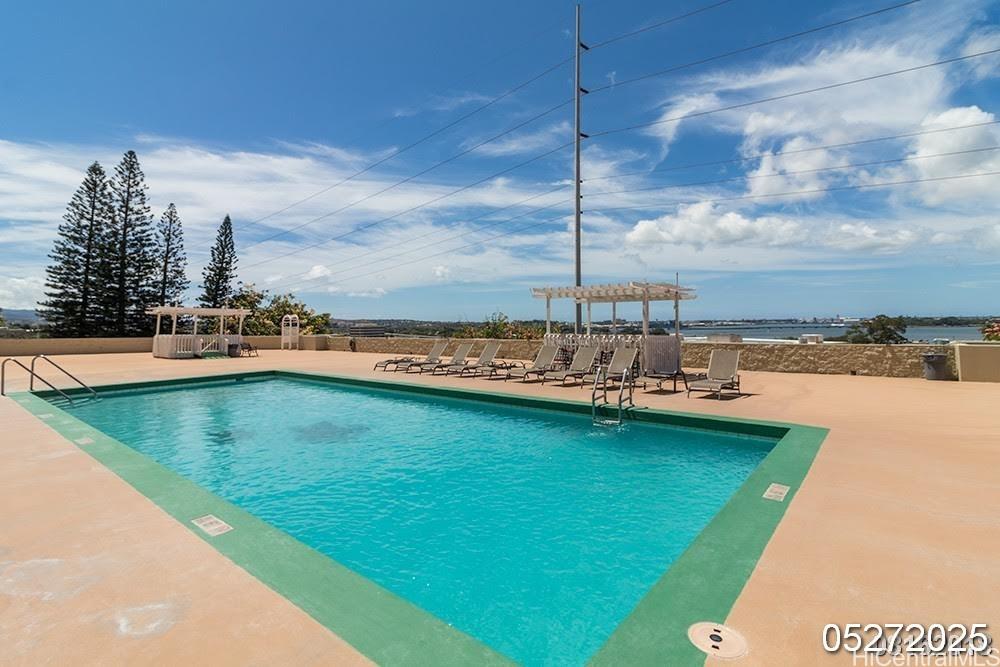 98-99 Uao Place, Unit 1705 Aiea, HI 96701 - Photo 22 of 25 a view of a swimming pool with an outdoor seating