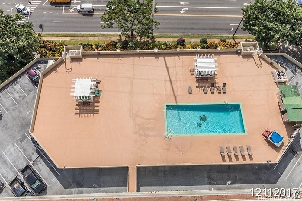 98-99 Uao Place, Unit 1705 Aiea, HI 96701 - Photo 25 of 25 a view of swimming pool with a yard and plants