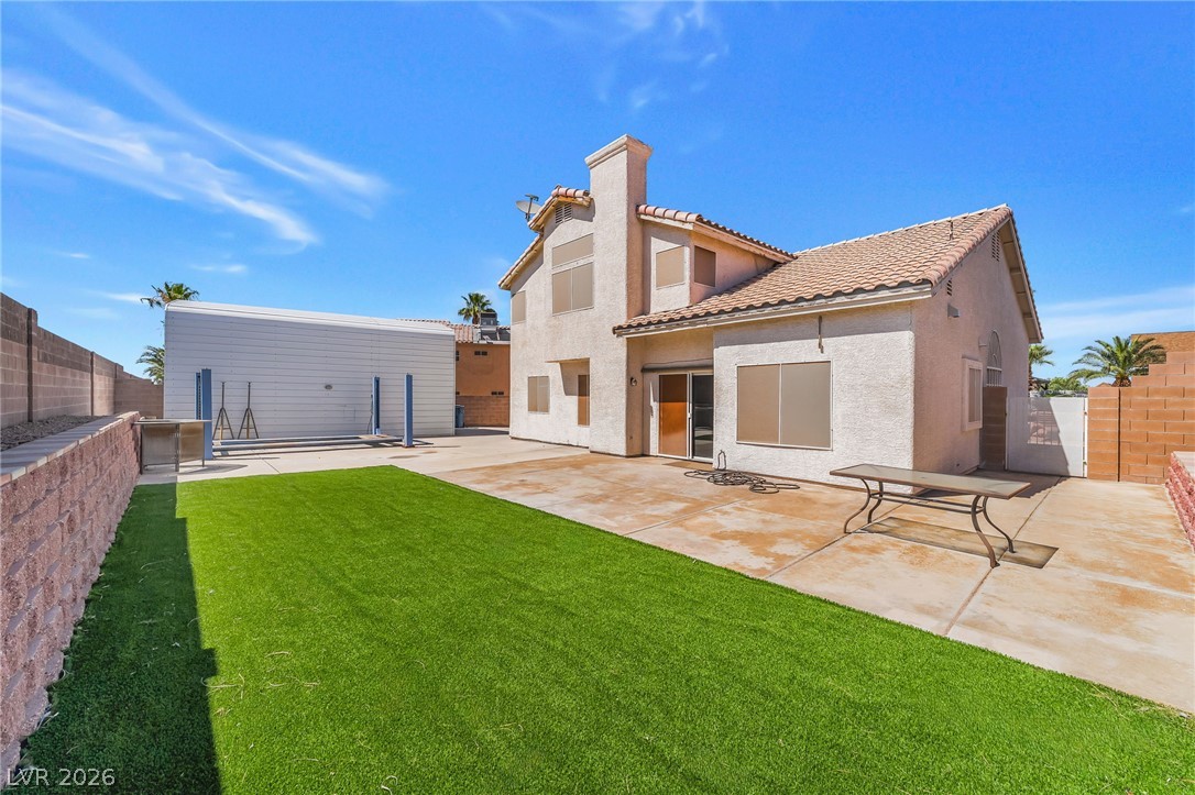 104 Appian Way Henderson, NV 89002 - Photo 22 of 24 A well-maintained yard offers both a grassed area and ample paved patio space for outdoor enjoyment.