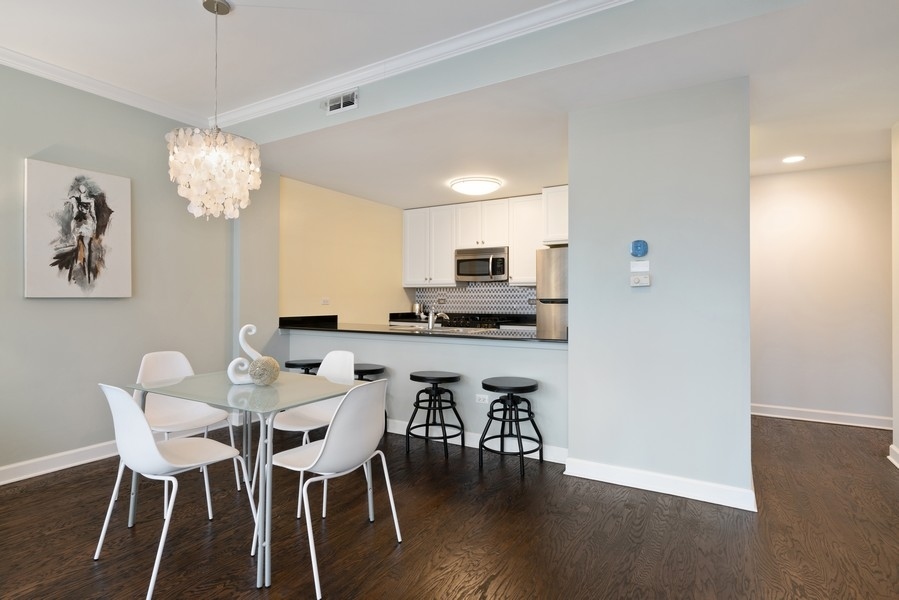 400 North Clinton Street, Unit 507 Chicago, IL 60654 - Photo 7 of 31 a view of a dining room with furniture and wooden floor