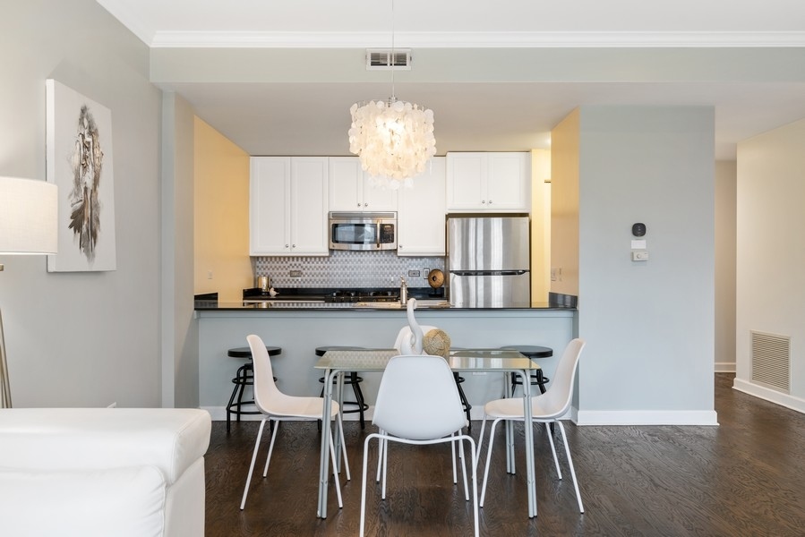 400 North Clinton Street, Unit 507 Chicago, IL 60654 - Photo 8 of 31 a view of a dining room with furniture and wooden floor