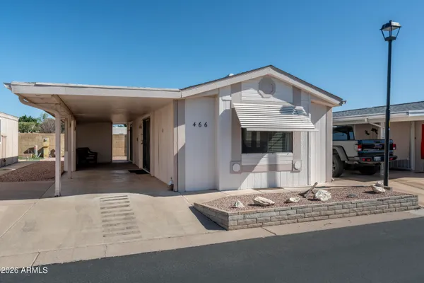 a view of a living room with a fireplace furniture and a large window