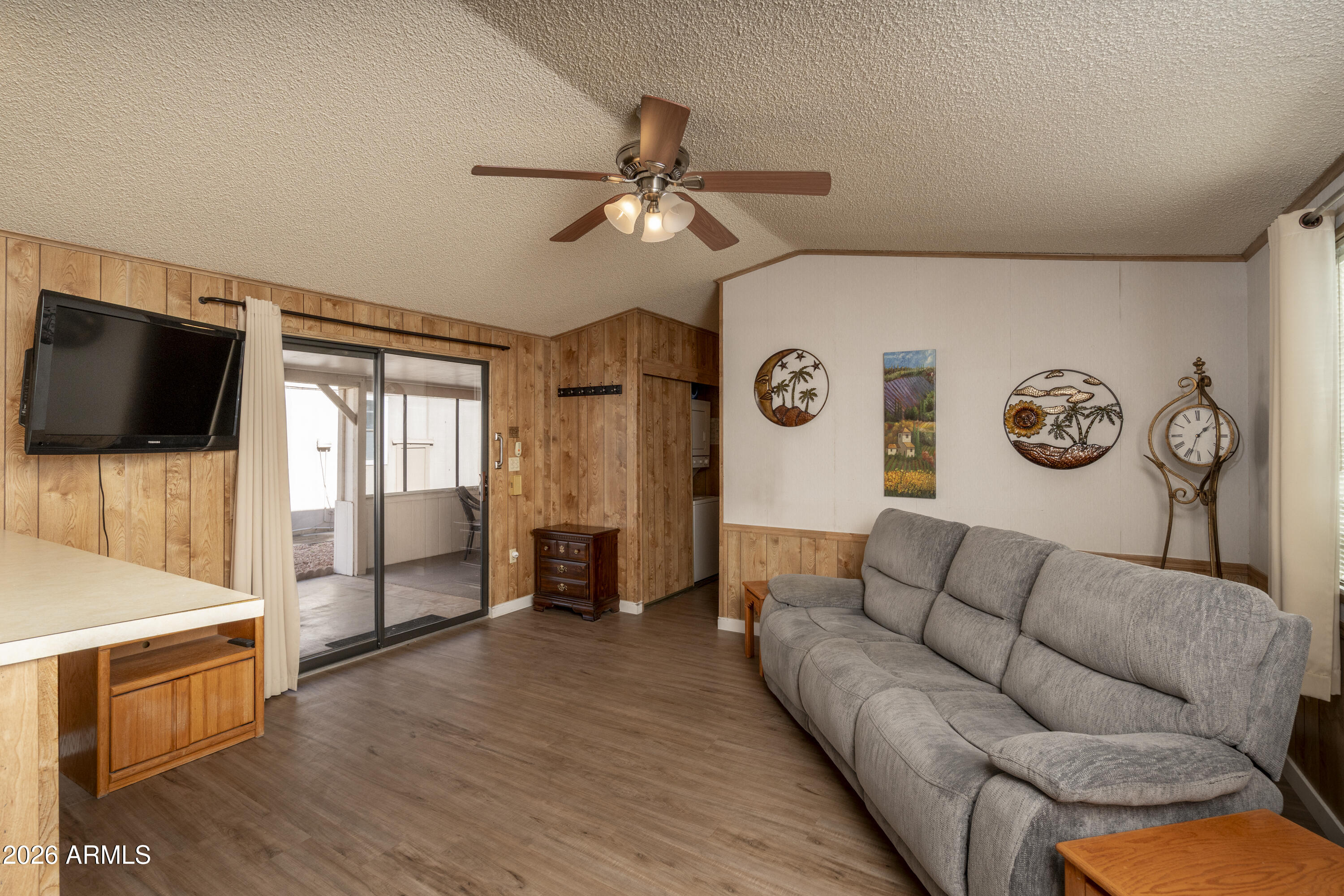 5735 East McDowell Road, Unit 466 Mesa, AZ 85215 - Photo 3 of 19 a living room with furniture and a flat screen tv