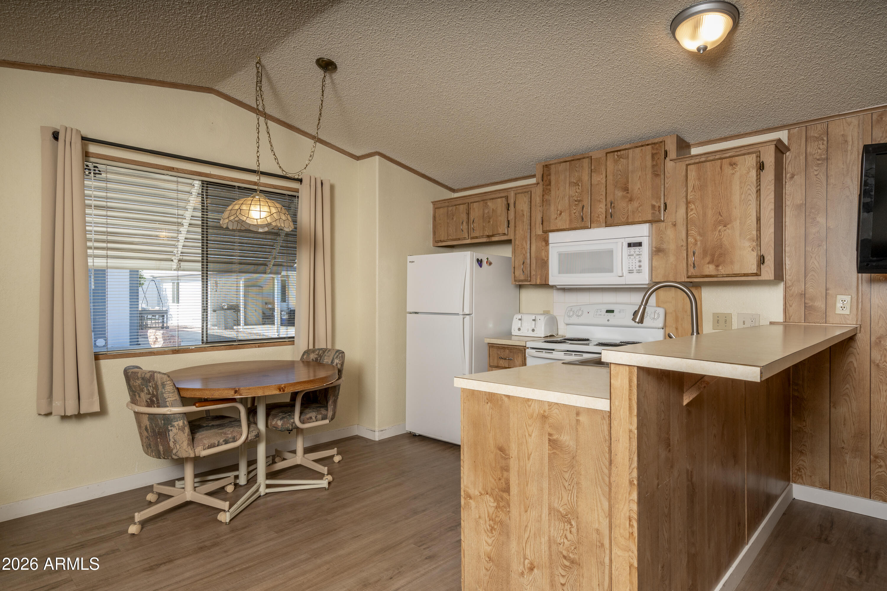 5735 East McDowell Road, Unit 466 Mesa, AZ 85215 - Photo 6 of 19 a kitchen with a sink a stove a refrigerator and cabinets