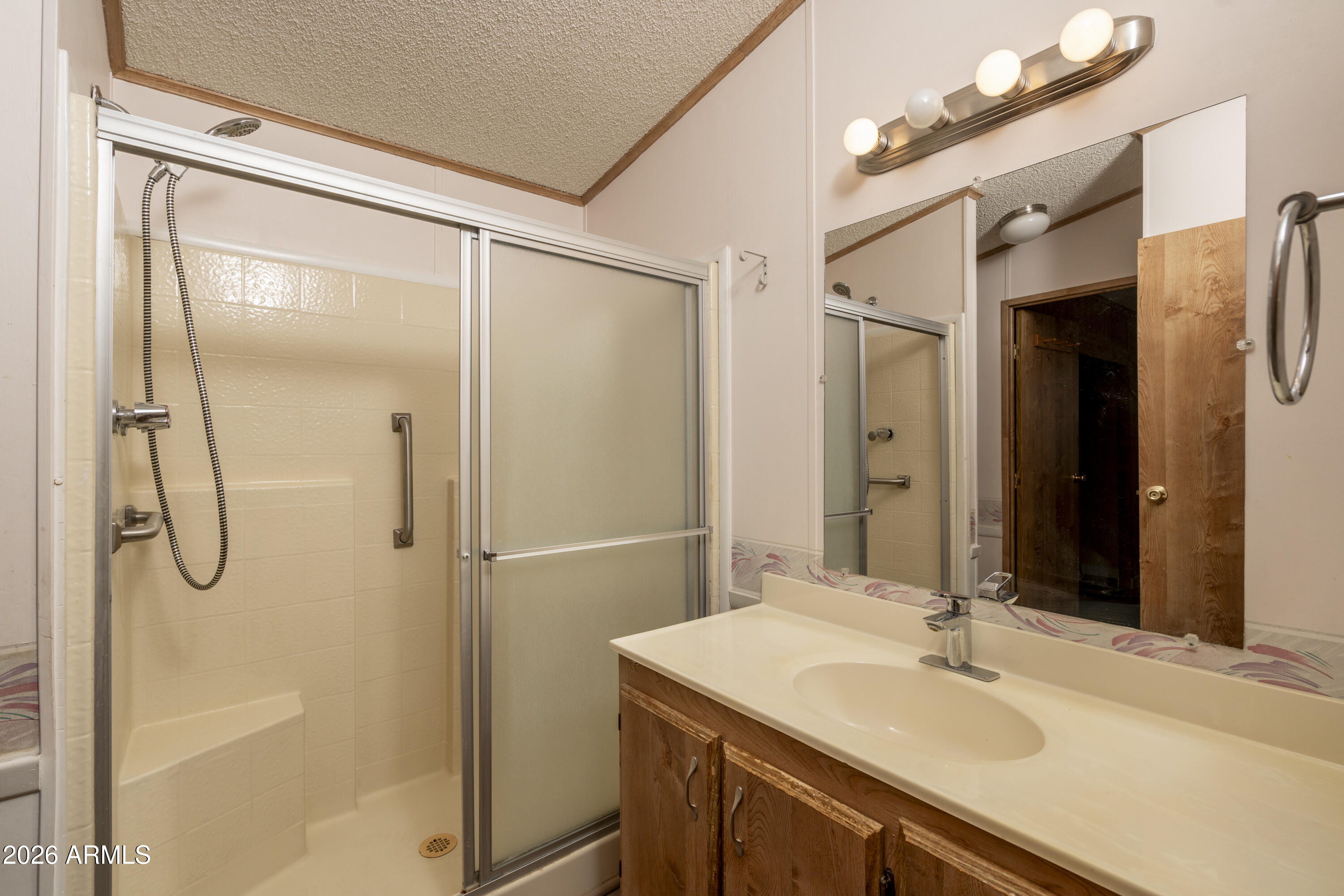 5735 East McDowell Road, Unit 466 Mesa, AZ 85215 - Photo 8 of 19 a bathroom with a sink vanity granite shower and a mirror