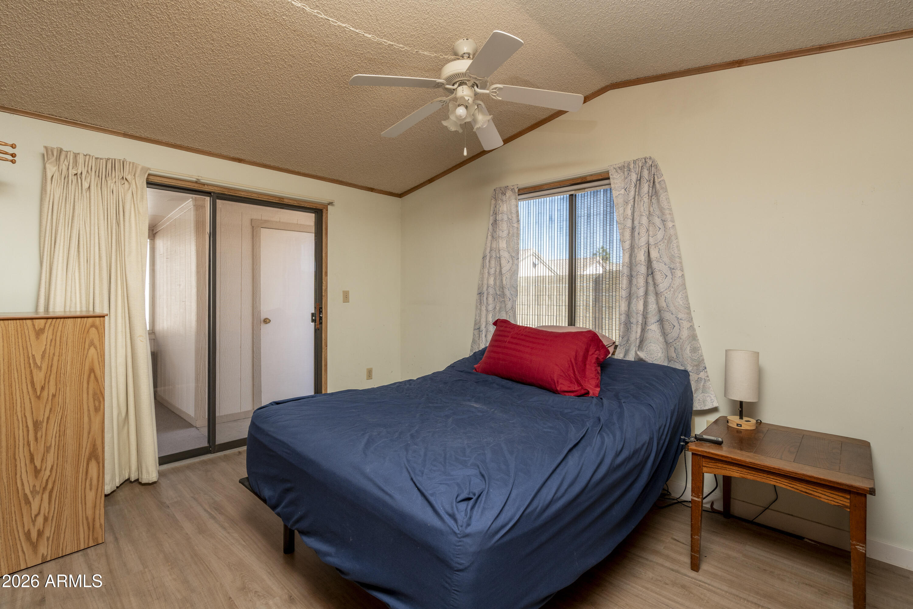 5735 East McDowell Road, Unit 466 Mesa, AZ 85215 - Photo 9 of 19 a bedroom with a bed and a chandelier