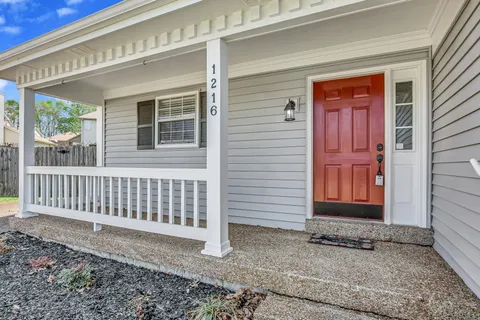 a view of a house with a wooden fence
