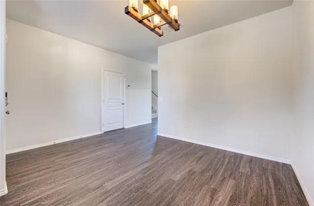 a view of a room with wooden floor and white walls