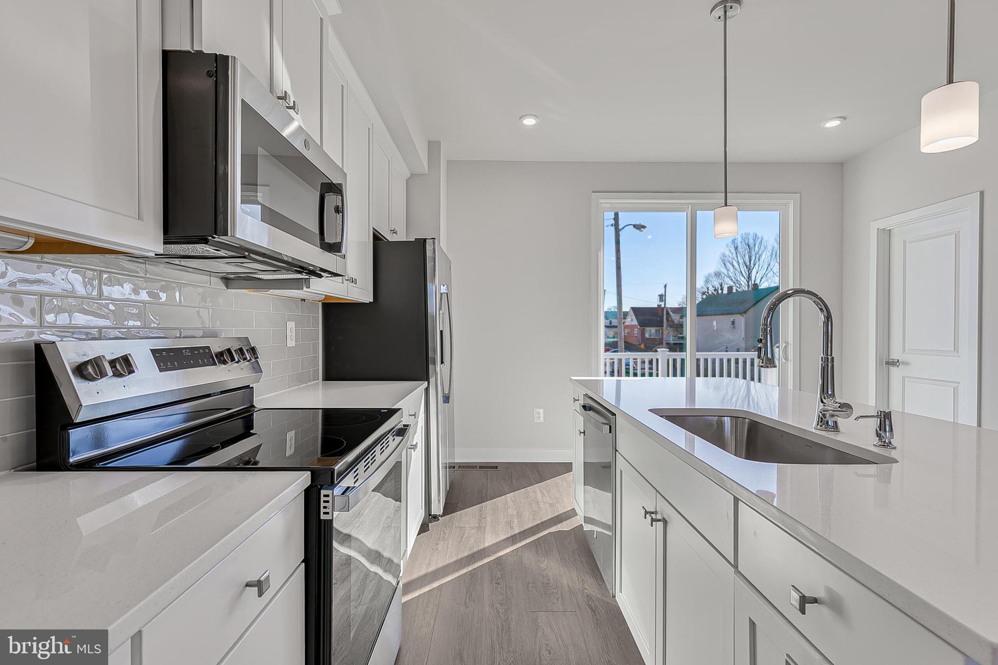 70 C Oasis Avenue Ranson, WV 25438 - Photo 14 of 41 a kitchen with stainless steel appliances granite countertop a sink and a stove