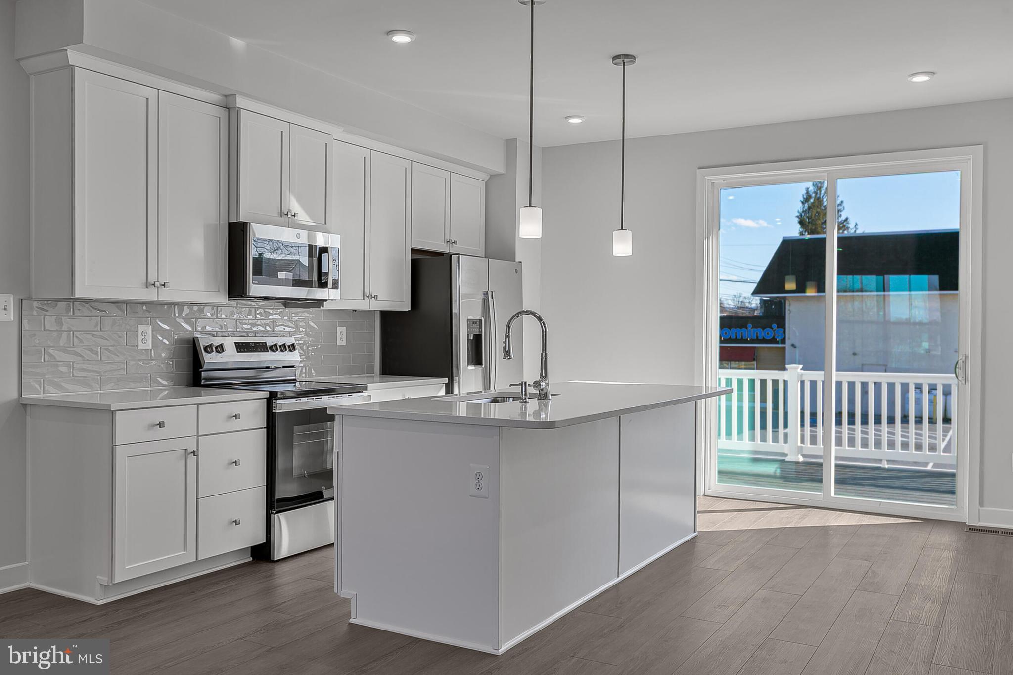 70 C Oasis Avenue Ranson, WV 25438 - Photo 16 of 41 a kitchen with kitchen island a counter top space appliances and cabinets