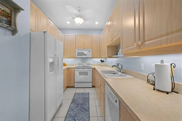 a kitchen with a sink a stove a refrigerator and cabinets