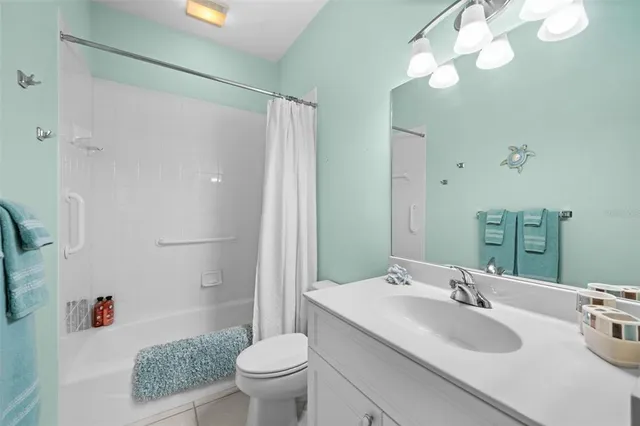 a bathroom with a granite countertop sink a toilet and a mirror