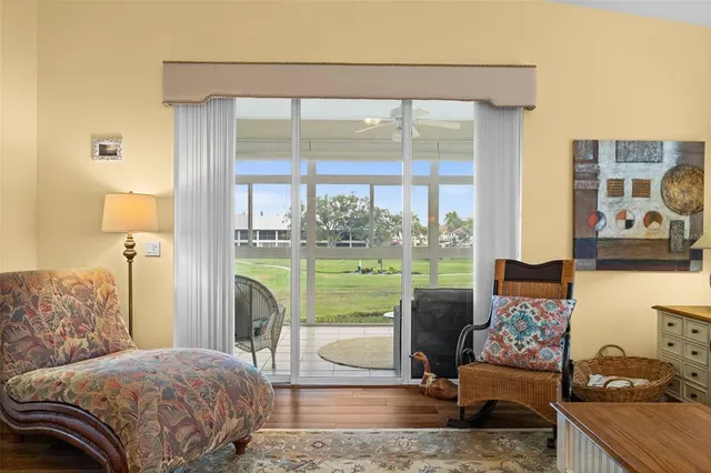 a bedroom with a bed and a large window with outer view