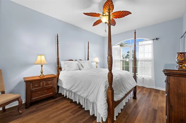 a bedroom with bed and wooden floor