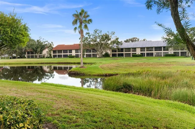 a view of a house with a yard and a garden