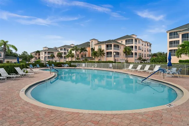 a view of a swimming pool with outdoor seating