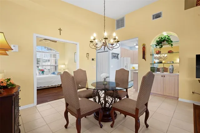 a dining room with furniture and chandelier