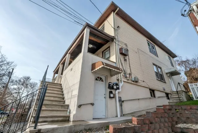 a view of a house with wooden stairs