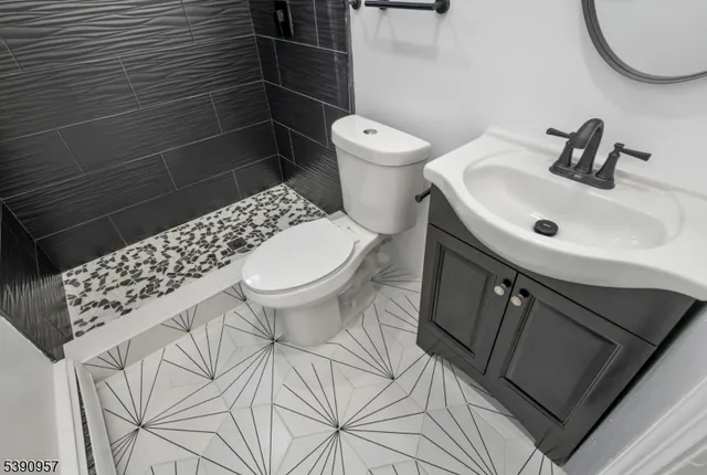 a bathroom with a sink toilet and a mirror