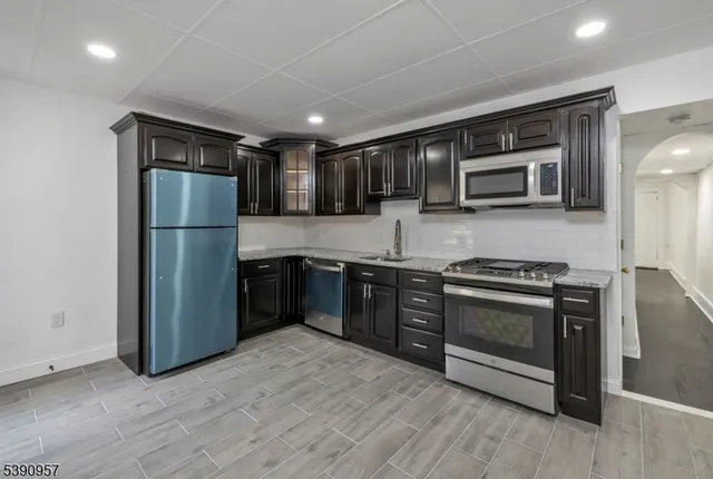 a kitchen with a refrigerator stove and microwave