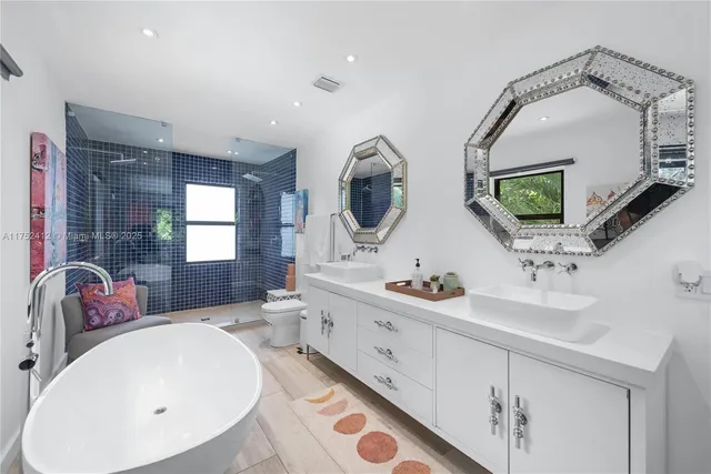 a en suite bathroom with double vanity sinks and a mirror