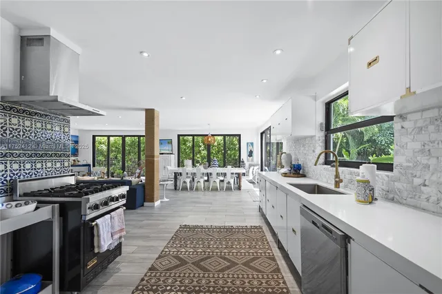 a kitchen with a stove a sink dishwasher a stove and a microwave oven