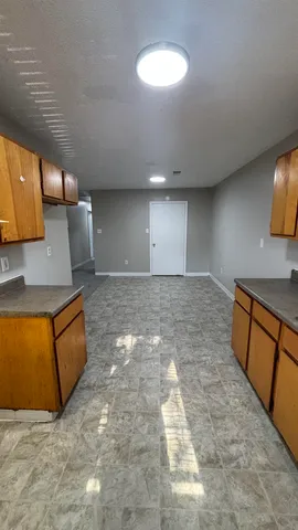 a view of a kitchen with a sink and a stove top oven