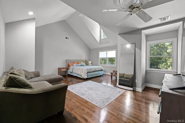 a bedroom with furniture and a large window