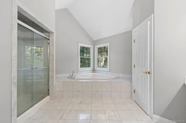 a spacious bathroom with a tub shower and sink