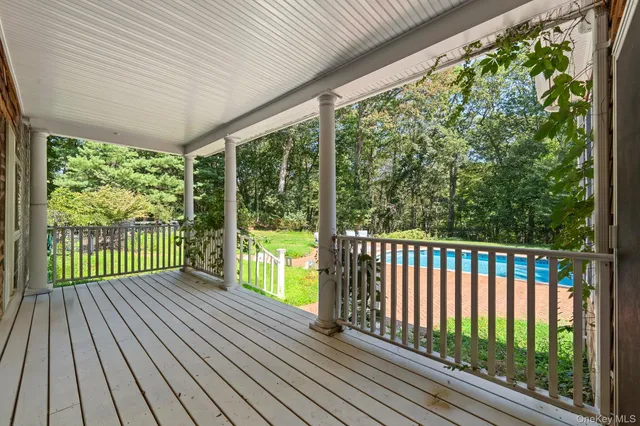 a view of porch with a lots of trees in the background