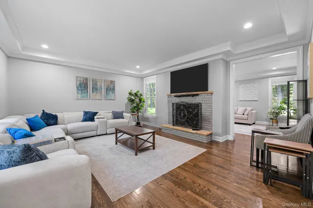 a living room with furniture a flat screen tv and a fireplace