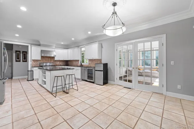 a kitchen with stainless steel appliances a refrigerator and microwave