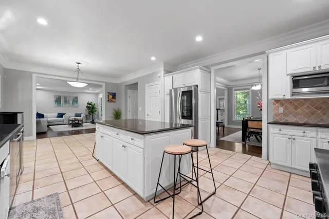 a large white kitchen with cabinets