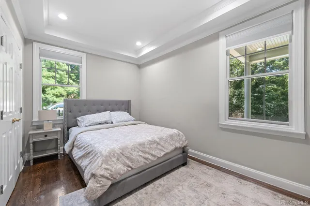 a bedroom with a bed lamp and window