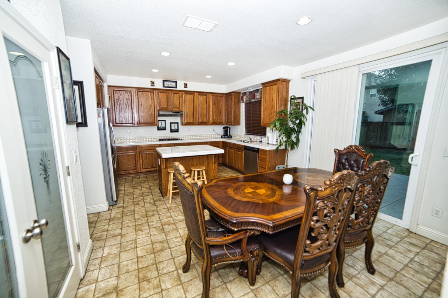 804 Pear Street Madera, CA 93638 - Photo 12 of 27 a dining room with stainless steel appliances a dining table and chairs