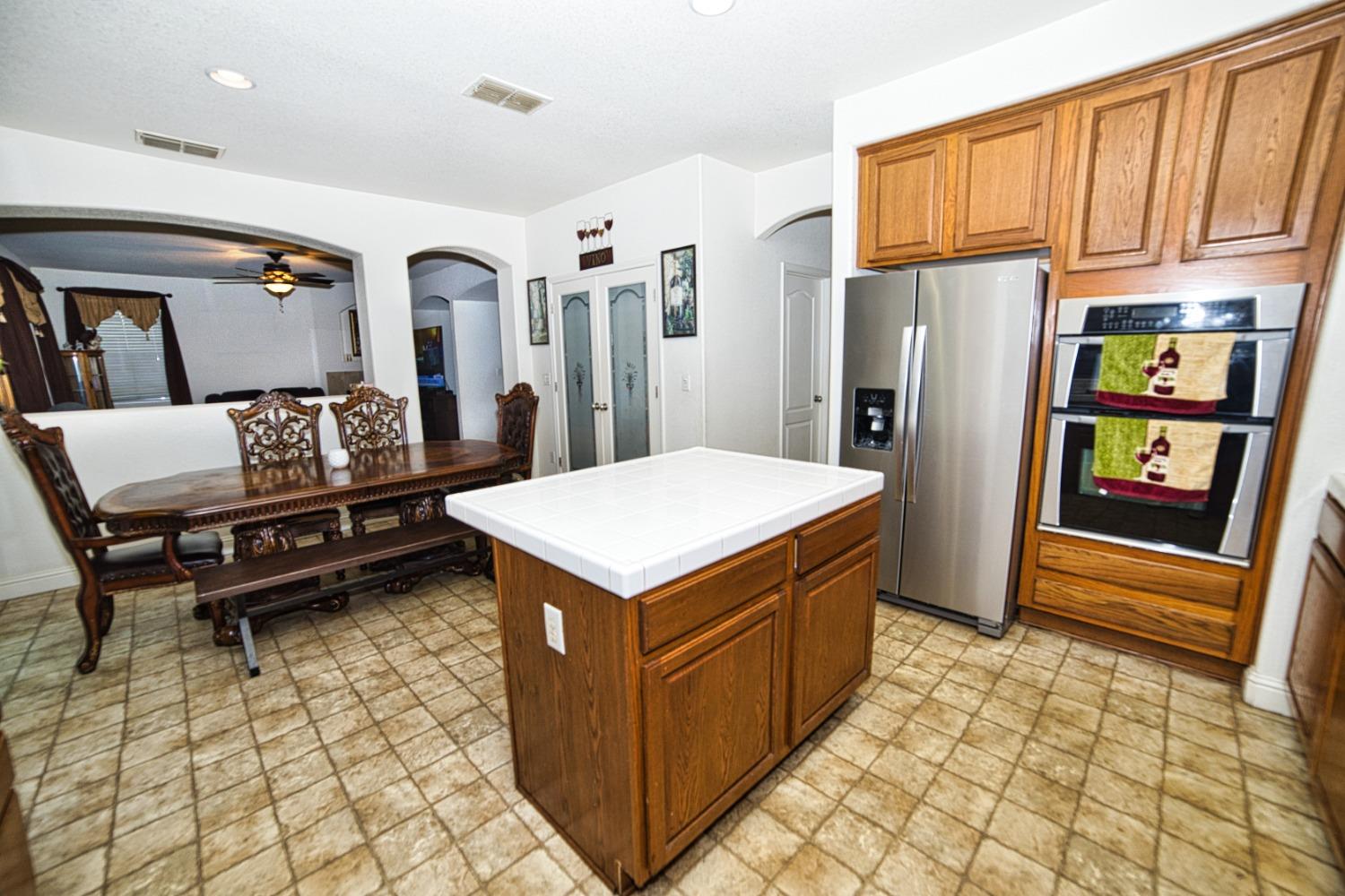 804 Pear Street Madera, CA 93638 - Photo 13 of 27 a kitchen with stainless steel appliances granite countertop a refrigerator and a stove