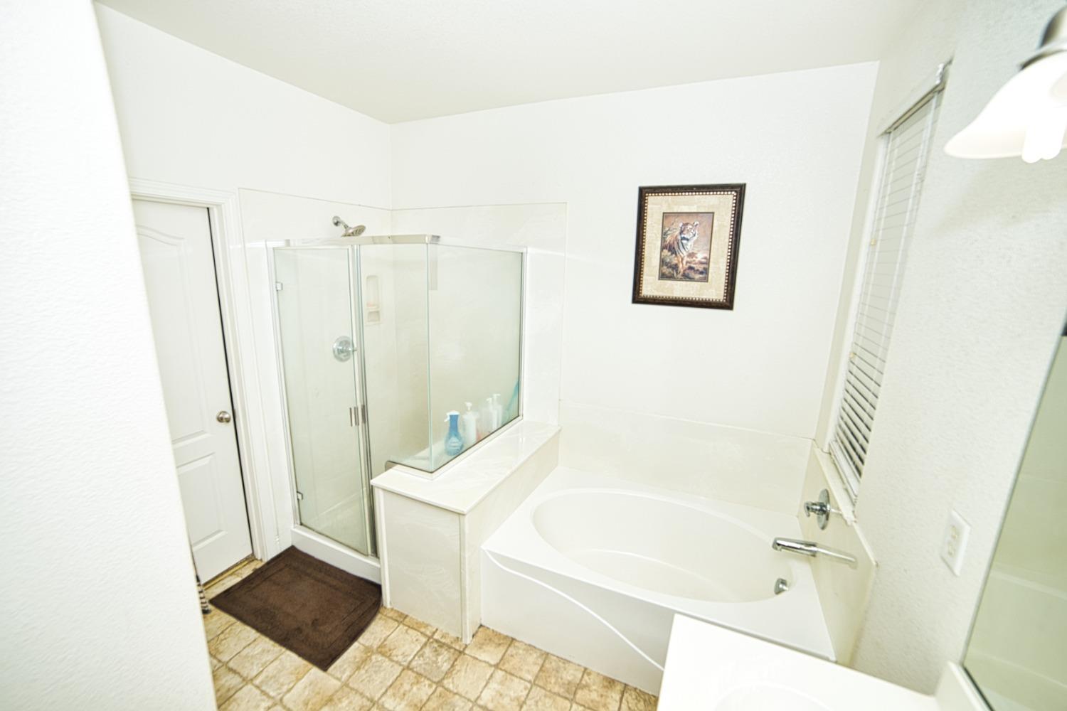 804 Pear Street Madera, CA 93638 - Photo 18 of 27 a bathroom with a bathtub and a shower