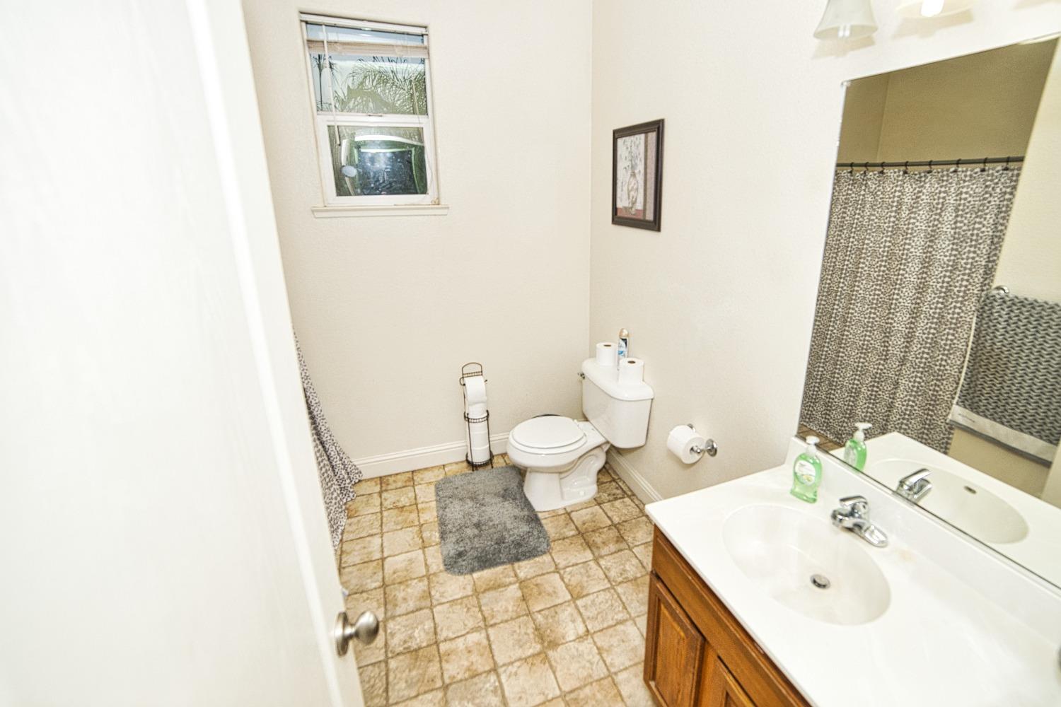 804 Pear Street Madera, CA 93638 - Photo 20 of 27 a bathroom with a sink and a toilet