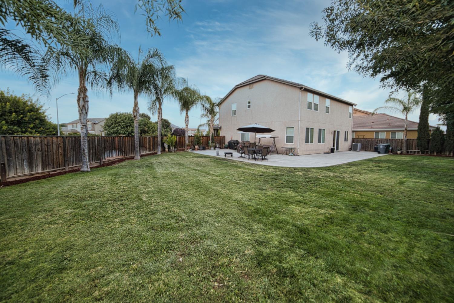 804 Pear Street Madera, CA 93638 - Photo 25 of 27 a view of a house with a yard and a patio