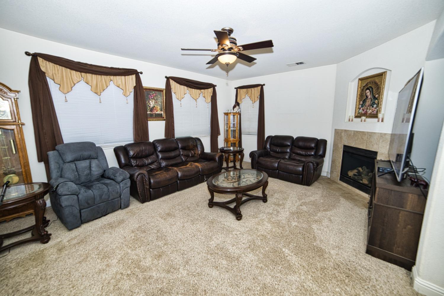 804 Pear Street Madera, CA 93638 - Photo 10 of 27 a living room with furniture and a fireplace