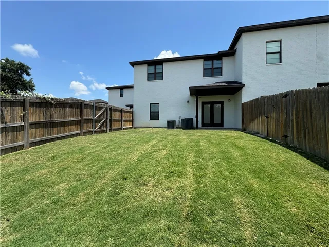 a view of a house with a yard and sitting area