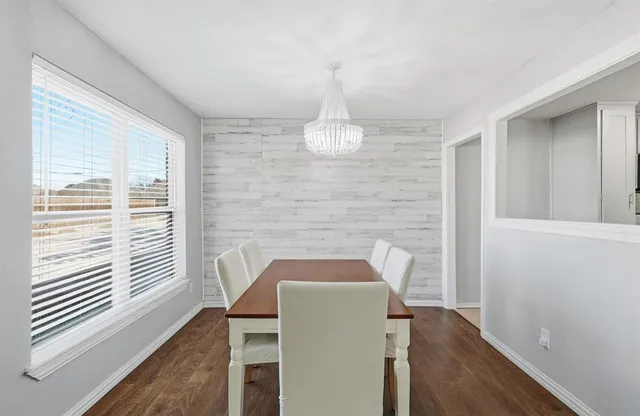 a view of wooden floor and chandelier in a room