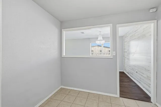 a room with a mirror and a wooden floor