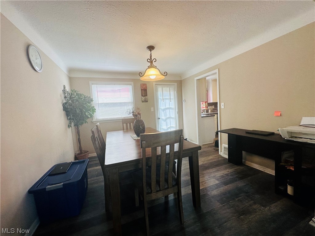 3894 Salisbury Road South Euclid, OH 44121 - Photo 5 of 16 Dining space featuring a textured ceiling and dark hardwood flooring