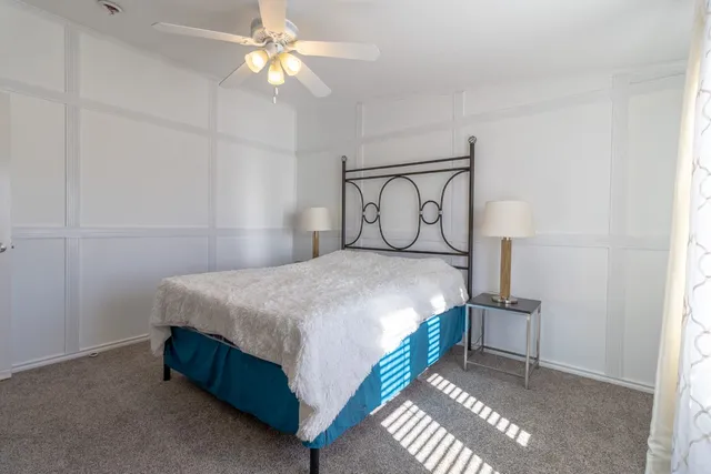 a bedroom with a bed and a chandelier