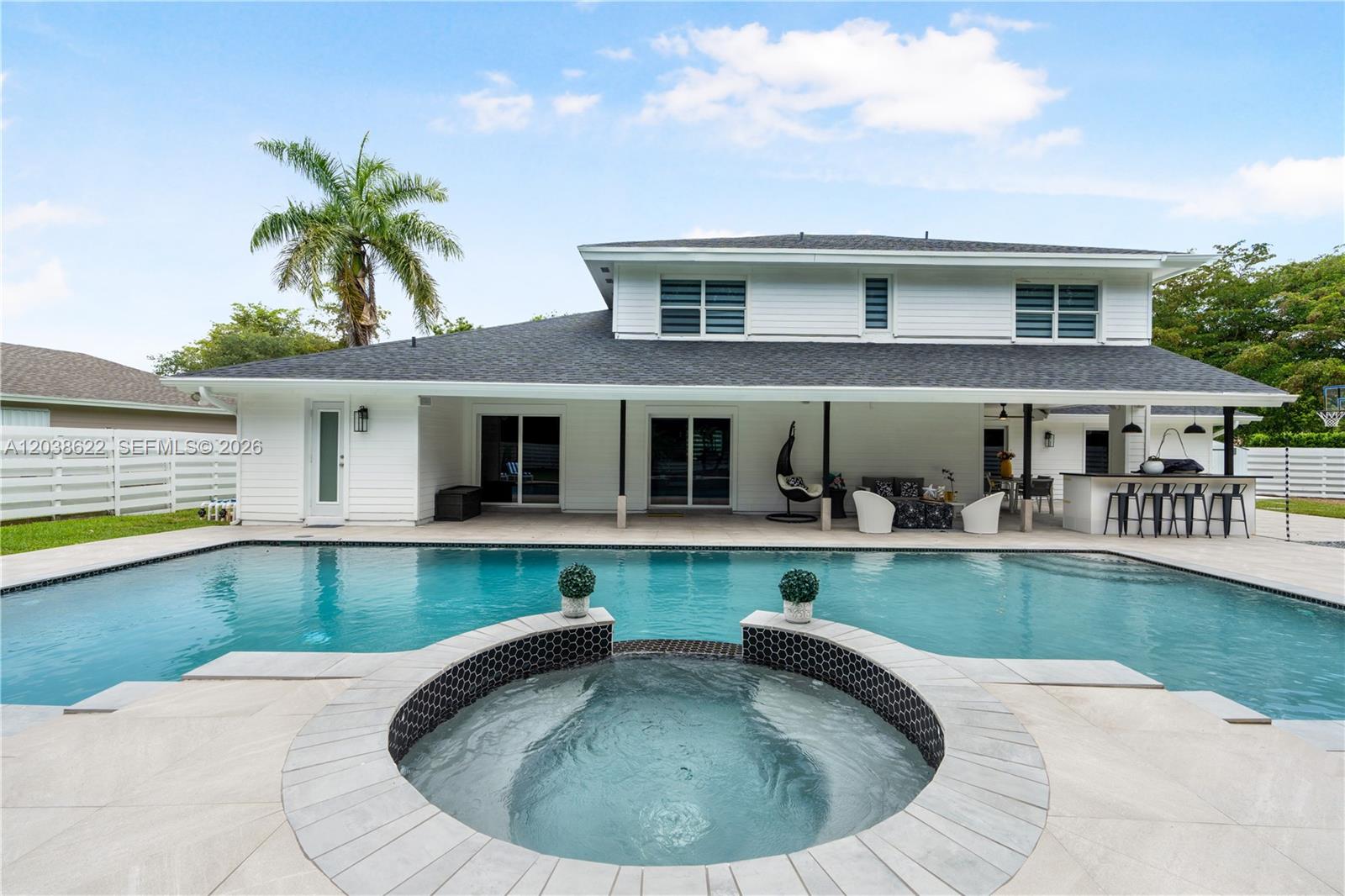 14830 Southwest 149th Street Miami, FL 33196 - Photo 24 of 43 a view of a house with swimming pool and a porch