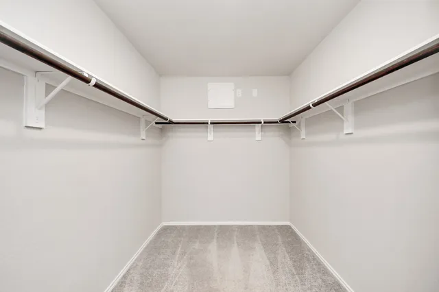 a spacious bathroom with a tub sink and mirror