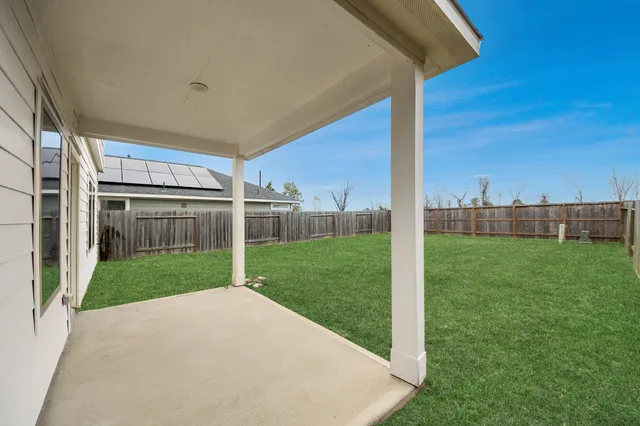 a view of a house with backyard and a garden